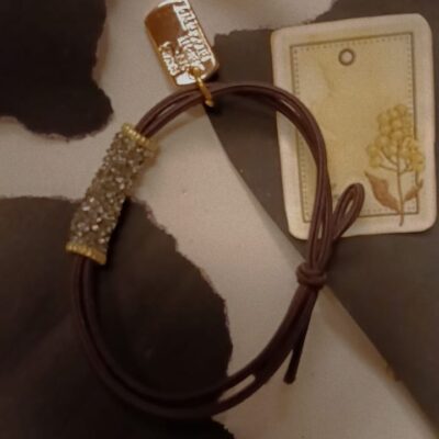 Crystal tube elastic hair tie with gold charm and crystal detailing in multiple colours.