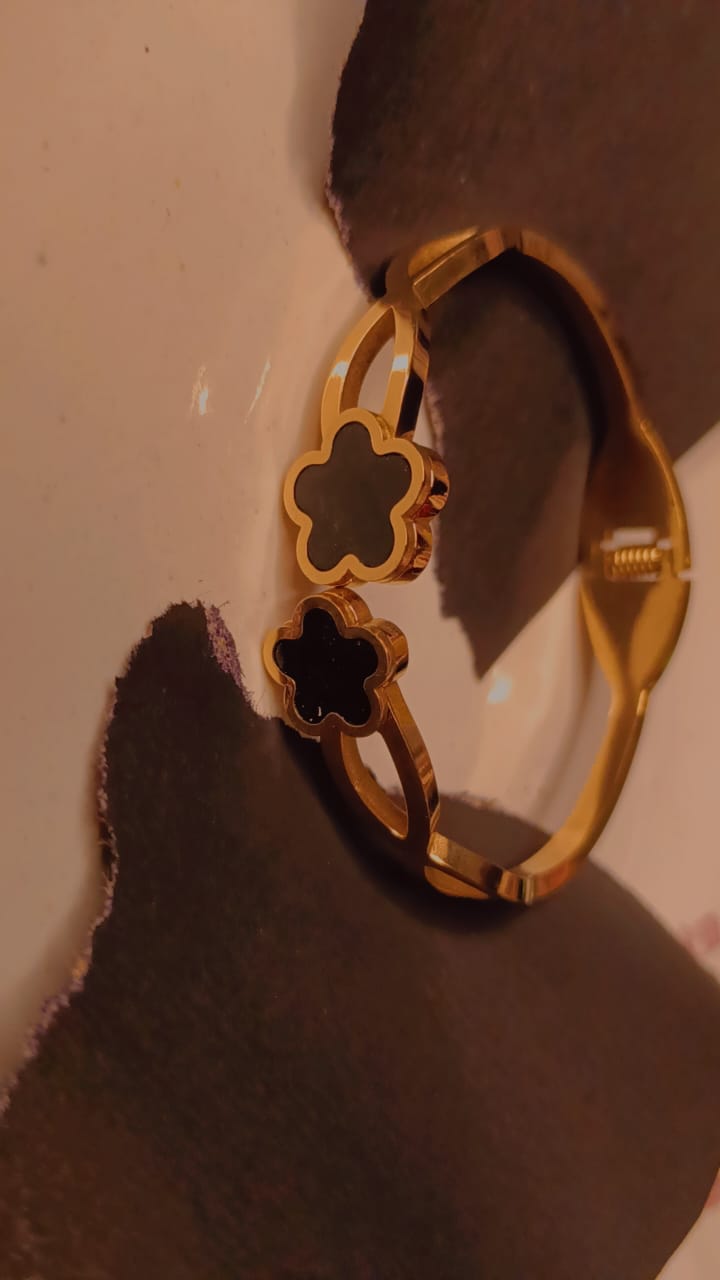 Gold barcelet with twin black clover charms and polished finish