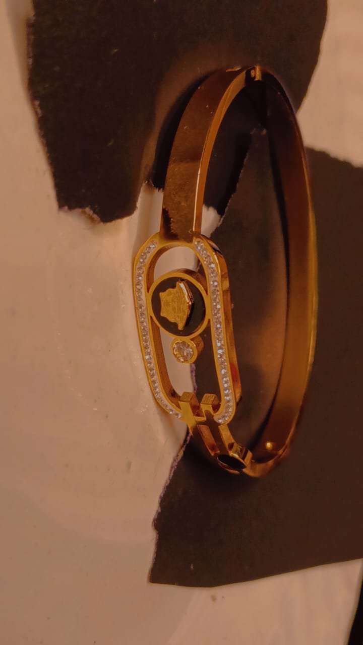 Elegant royal gold bracelet with crystal border and emblem centrepiece