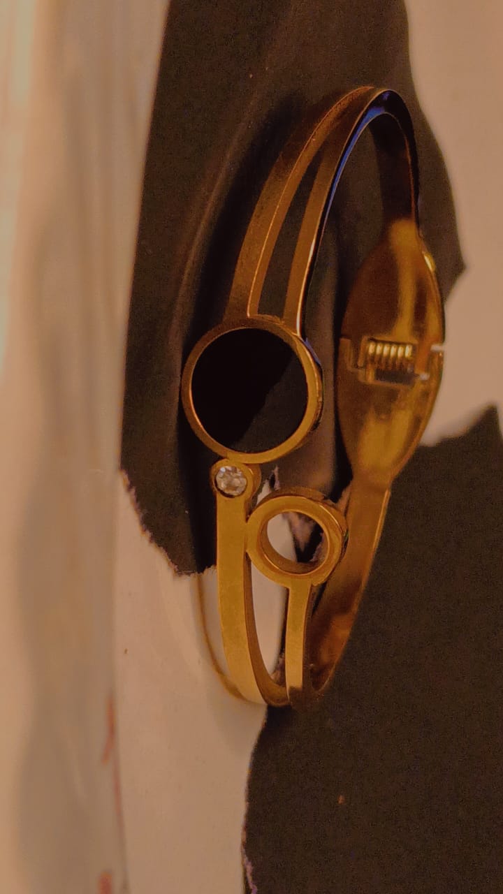 Elegant gold bracelet with dual circle design and sparkling crystal accent