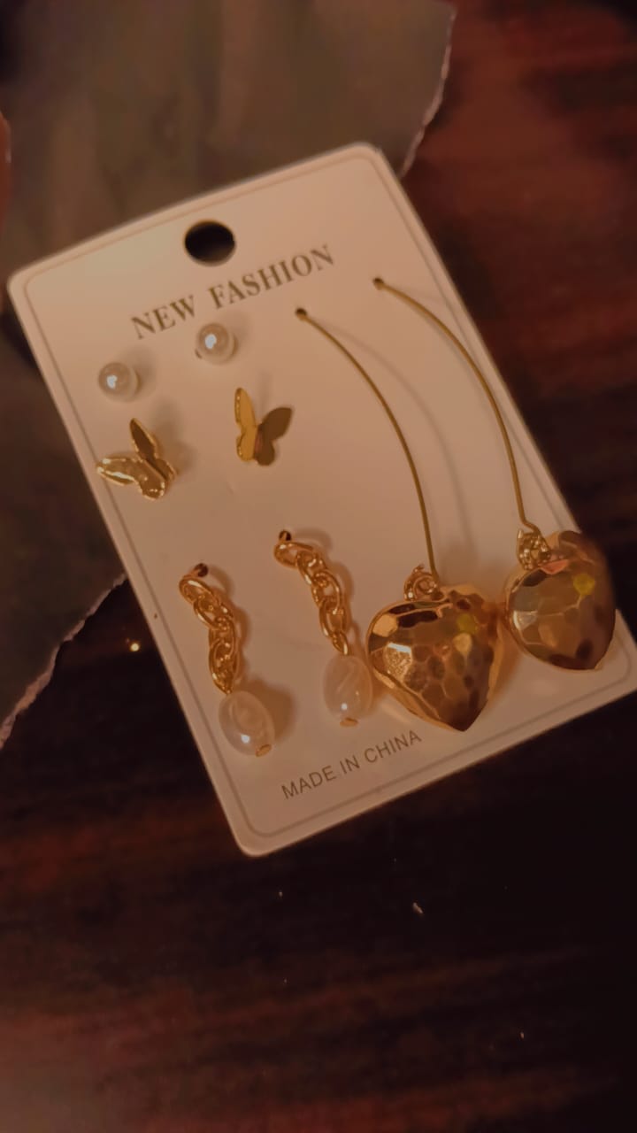 Gold combo earrings set with butterfly, pearl, and heart designs on display card.