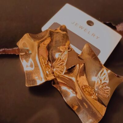 Gold wavy earrings with butterfly design by Pearlith