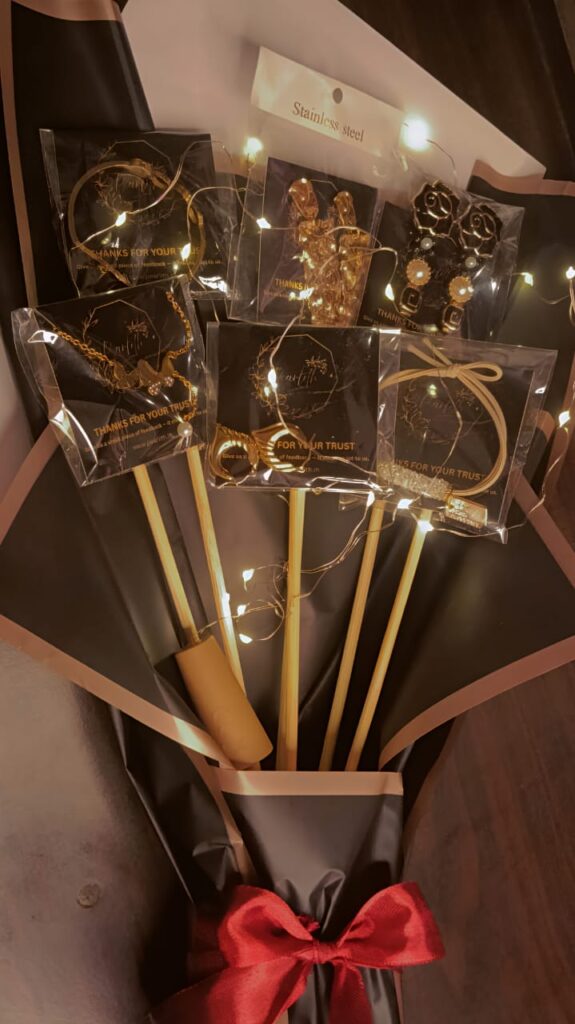 Golden jewelry bouquet with stainless steel accessories and fairy light