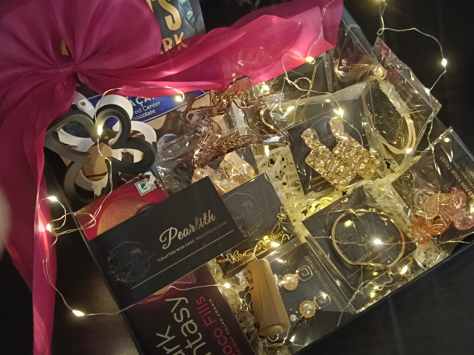 Pearlith luxury gift hamper containing chocolates, jewellery, hair accessories, and fairy lights arranged in a decorative box
